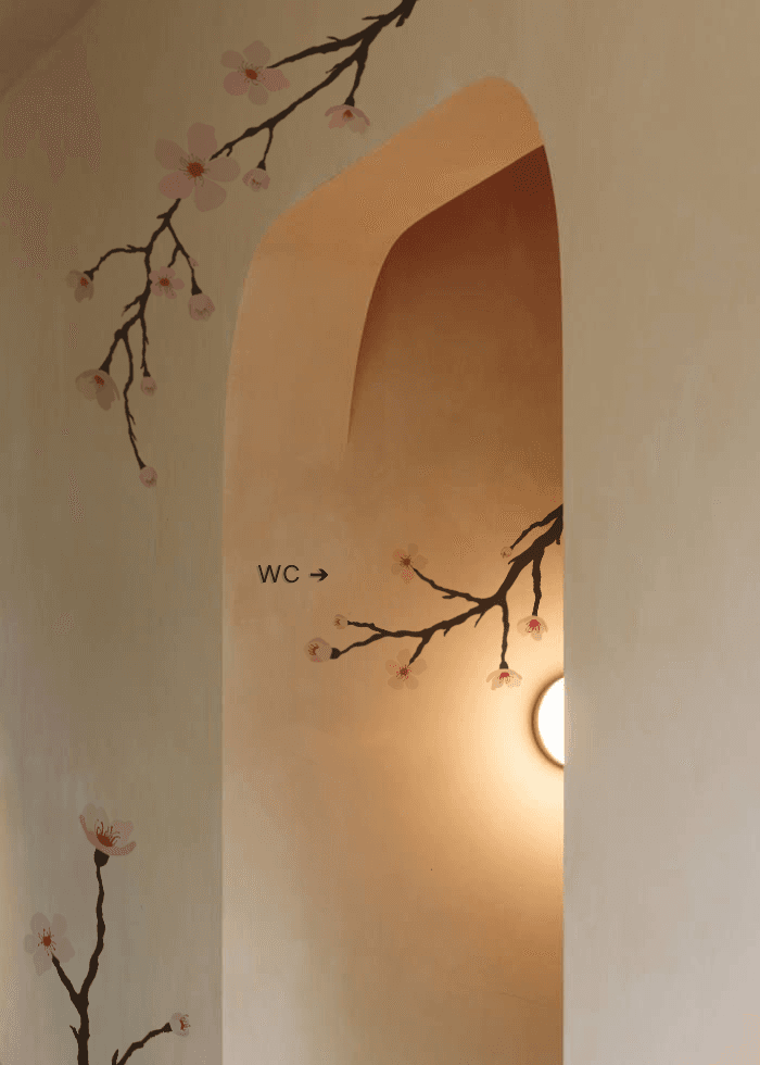 Hanami cafe hallway with cherry blossom decal and WC signage